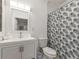 Well-lit bathroom featuring a modern vanity, toilet, and decorative shower curtain at 261 Fletcher Sw St, Atlanta, GA 30315