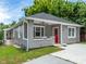 Gray house with red door, a porch, and a well-manicured lawn at 261 Fletcher Sw St, Atlanta, GA 30315