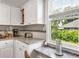 Bright kitchen featuring granite countertops, white cabinets, and a window with a view of lush greenery at 261 Fletcher Sw St, Atlanta, GA 30315