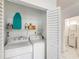 Convenient laundry closet including washer, dryer, shelving, and cleaning supplies at 261 Fletcher Sw St, Atlanta, GA 30315