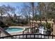 Backyard featuring a swimming pool, pergola with grill, and lush landscaping at 4086 Haverhill Dr, Atlanta, GA 30342