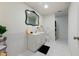 Clean bathroom featuring a single sink vanity, mirror, toilet, and tiled walls and flooring at 4086 Haverhill Dr, Atlanta, GA 30342