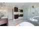 The bathroom is clad in marble-look tile, has a glass shower, and a soaking tub at 4086 Haverhill Dr, Atlanta, GA 30342