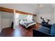 Bedroom featuring vaulted ceilings, exposed wood beams, skylights, and a cozy seating area with a sofa and TV at 4086 Haverhill Dr, Atlanta, GA 30342