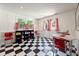 Bonus room with black and white checkered floor, bright windows and red chairs at 4086 Haverhill Dr, Atlanta, GA 30342