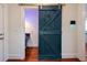 Hallway with view of bathroom, tile floors and a barn door at 4086 Haverhill Dr, Atlanta, GA 30342