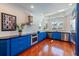 Bright kitchen with stainless steel appliances, blue cabinets, and a window with a backyard view at 4086 Haverhill Dr, Atlanta, GA 30342