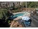 Aerial view of a private backyard oasis featuring a gunite pool, hot tub, deck, and patio with gazebo and lounge area at 4086 Haverhill Dr, Atlanta, GA 30342