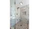 Modern shower with pebble floor, frameless glass door and marble-look surround at 4086 Haverhill Dr, Atlanta, GA 30342