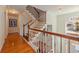 Beautiful home staircase with wood handrail, white spindles and hardwood floors at 4086 Haverhill Dr, Atlanta, GA 30342