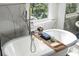 The soaking tub features a convenient wood tray with a place for bath products at 4086 Haverhill Dr, Atlanta, GA 30342