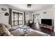 Bright living room featuring a neutral color palette, hardwood floors, stylish furnishings, and a large window at , Tucker, GA 30084