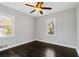 Spacious bedroom featuring dark hardwood floors and a ceiling fan at 1664 Columbia Dr, Decatur, GA 30032