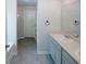 Bathroom featuring a double sink vanity with large mirror and neutral wall color for a modern and clean space at 3573 Stonebranch Ln, Loganville, GA 30052