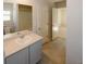 Bright bathroom with a tiled floor, light countertops, and a door to the bedroom at 3573 Stonebranch Ln, Loganville, GA 30052