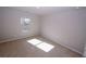 A sunlit bedroom with neutral walls, carpeting, and a window offering natural light at 3573 Stonebranch Ln, Loganville, GA 30052