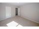 Neutral bedroom with carpeted floors and neutral walls offers a serene atmosphere with two doors at 3573 Stonebranch Ln, Loganville, GA 30052