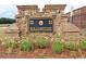 Stone welcome sign for Hollowstone neighborhood with gold lettering and manicured landscaping at 3573 Stonebranch Ln, Loganville, GA 30052