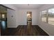 Dining room featuring dark wood flooring and view to kitchen at 3573 Stonebranch Ln, Loganville, GA 30052