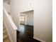 Bright and airy entryway showcasing hardwood floors, carpeted stairs, and a view into a sunlit room at 3573 Stonebranch Ln, Loganville, GA 30052