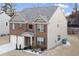 Two-story brick and beige home with a three-car garage at 3573 Stonebranch Ln, Loganville, GA 30052