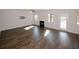 Bright living room with a modern fireplace, ceiling fan, and beautiful hardwood flooring at 3573 Stonebranch Ln, Loganville, GA 30052