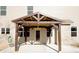 Covered patio with pergola extends from a door at the rear of the home at 3573 Stonebranch Ln, Loganville, GA 30052