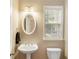 Clean powder room with pedestal sink and a window at 4701 Wehunt Se Trl, Smyrna, GA 30082