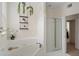 Bright bathroom featuring a soaking tub, glass shower, and elegant decor at 951 Glenwood Se Ave # 1201, Atlanta, GA 30316