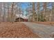 Front view of a ranch home nestled among trees with a long driveway at 4149 Golfview Dr, Villa Rica, GA 30180