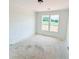 A bedroom with white walls, trim and a double window overlooking a green yard at 1275 Pj East Rd, Covington, GA 30014