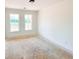 A bedroom with white walls, trim and a double window overlooking a green yard at 1275 Pj East Rd, Covington, GA 30014