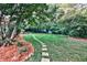 Landscaped backyard with lush lawn and stone pathway at 496 Longview Dr, Norcross, GA 30071