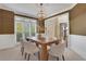 Formal dining room featuring a wood table, chandelier, and wainscoting at 1215 Wynridge Xing, Alpharetta, GA 30005