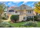 Two-story house with beige siding, gray roof, and landscaping at 1215 Wynridge Xing, Alpharetta, GA 30005