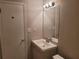 Simple bathroom with a sink, toilet and mirror at 2043 Laird Rd, Hiram, GA 30141