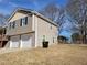 Side view of tan house with a two-car garage at 2043 Laird Rd, Hiram, GA 30141