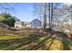 Secluded backyard with shed, stonework, and wooded area at 4392 Overlook Dr, Acworth, GA 30101