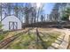 Landscaped backyard with shed and stone fire pit at 4392 Overlook Dr, Acworth, GA 30101