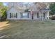 Gray house with dark brown shutters, a porch, and American flag at 4392 Overlook Dr, Acworth, GA 30101