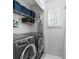 Bright laundry room, washer, dryer, shelving for storage at 4392 Overlook Dr, Acworth, GA 30101