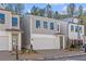 Modern gray house with a white garage door and a landscaped yard at 731 Stickley Oak Way, Woodstock, GA 30189