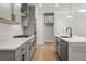 Modern kitchen with gray cabinets, quartz countertops, and stainless steel appliances at 731 Stickley Oak Way, Woodstock, GA 30189