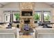 Living room with stone fireplace and views of the pool at 731 Stickley Oak Way, Woodstock, GA 30189