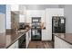 Kitchen featuring white cabinets, modern appliances, and a dark countertop at 401 16Th Nw St # 1179, Atlanta, GA 30363