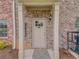 Charming brick townhome entrance with stylish front door and well-maintained landscaping at 3406 Mount Zion Rd, Stockbridge, GA 30281