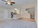 Open-concept living room with plush carpet flooring, ceiling fan and natural light at 3406 Mount Zion Rd, Stockbridge, GA 30281