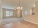 Open-concept living room with modern chandelier and vinyl plank flooring at 3406 Mount Zion Rd, Stockbridge, GA 30281