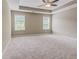 Spacious main bedroom with trey ceiling, large windows, and neutral carpet at 3406 Mount Zion Rd, Stockbridge, GA 30281