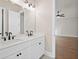 Double vanity bathroom with modern fixtures and white cabinets at 89 Batten Board Way, Woodstock, GA 30189